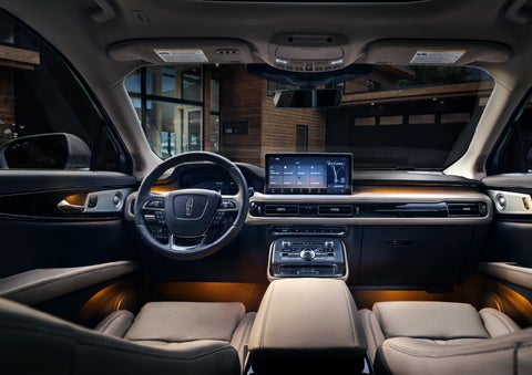 Available ambient lighting illuminates the cabin of a Lincoln Nautilus® SUV.