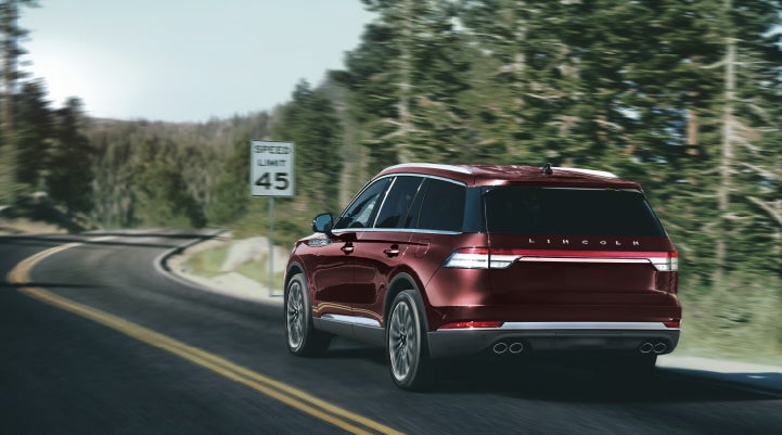 A 2024 Lincoln Aviator® SUV is being driven on a winding mountain road | West Point Lincoln of Sugar Land in Houston TX