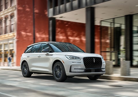 The 2024 Lincoln Corsair® SUV with the Jet Appearance Package and a Pristine White exterior is parked on a city street. | West Point Lincoln of Sugar Land in Houston TX