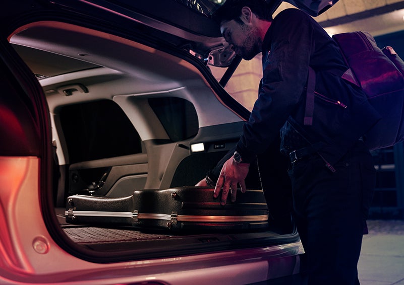 A man is shown loading cargo into the rear of a 2024 Lincoln Corsair® SUV with the second-row seats folded flat. | West Point Lincoln of Sugar Land in Houston TX